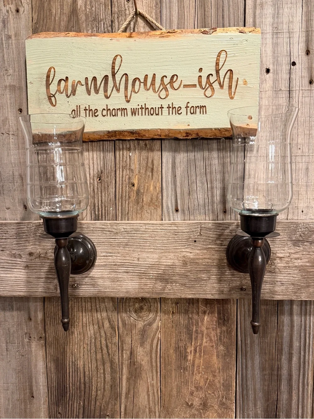 Pair of farmhouse dark bronze-toned metal candle sconces with clear glass